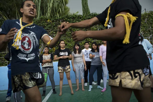 In this August 25, 2017 photo, Muay Thai practitioners demonstrate self-defense moves to mostly female students at a nursing school in Nezahualcoyotl, Mexico state. The mounting crisis of femicides – murders of women where the motive is directly related to gender – prompted the federal government to issue a gender violence alert in 2015, the first for any Mexican state. (Photo by Rebecca Blackwell/AP Photo)