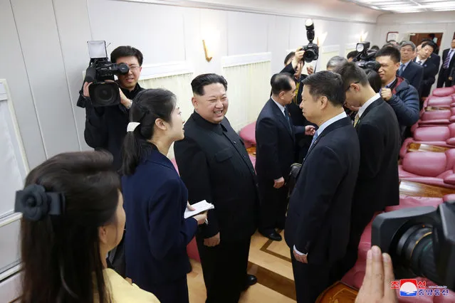 North Korean leader Kim Jong Un laughs with Chinese officials inside his bulletproof train as he paid an unofficial visit to Beijing on March 28, 2018. (Photo by Reuters/KCNA)