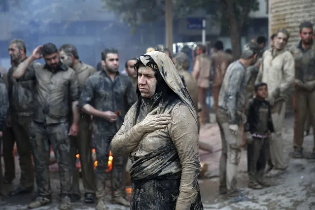 Iranian Shiite Muslims mourn after covering themselves with mud during Ashoura rituals, in Khorramabad, Iran, Wednesday, October12, 2016. Shiites mark Ashoura, the tenth day of the Muslim month of Muharram, to commemorate the martyrdom of Imam Hussein, a grandson of Prophet Muhammad and one of Shiite Islam's most beloved saints, during the 7th century Battle of Karbala in present-day Iraq. (Photo by Ebrahim Noroozi/AP Photo)