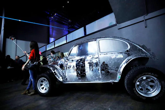 A guest takes a selfie by a Volkswagen Beetle during a VIP media preview ahead of the opening of The Museum of Selfies in Glendale, California, U.S., March 29, 2018. (Photo by Mario Anzuoni/Reuters)