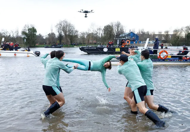 Coxswain Jasper Parish of Cambridge University Men's Boat Club is thrown into the Thames by teammates after Cambridge University Men's Boat Club defeat Oxford University Men's Boat Club during The Gemini Boat Race 2023 on March 26, 2023 in London, England. (Photo by Andrew Boyers/Action Images via Reuters)