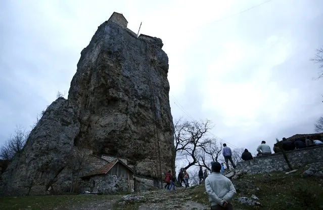 A local man looks at the church on top of the Katskhi Pillar, a rock mass about 40 meters high, in the village of Katskhi, Georgia, November 27, 2015. (Photo by David Mdzinarishvili/Reuters)