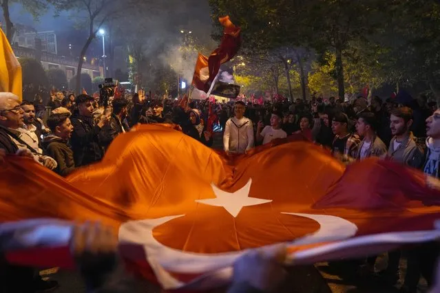 Supporters of President Recep Tayyip Erdogan celebrate outside AKP (Justice and Development Party) headquarters in Istanbul, Turkey, Sunday, May 14, 2023. More than 64 million people, including 3.4 million overseas voters, were eligible to vote. (Photo by Khalil Hamra/AP Photo)