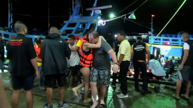 A rescued woman wearing a life jacket hugs a man after a boat capsized off the tourist island of Phuket, Thailand July 5, 2018 in this still image taken from video. A boat carrying dozens of Chinese tourists overturned in rough seas off southern Thailand and dozens of passengers were unaccounted for, the Phuket governor said. (Photo by Reuters via Reuters TV)