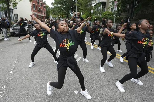 Performers in the MAJORHYPE dance company dance as they make their way along the route of a parade held to commemorate Juneteenth, Monday, June 19, 2023, in Boston. Americans across the country are observing the relatively new Juneteenth federal holiday with festivals, parades, cookouts and other gatherings. (Photo by Steven Senne/AP Photo)