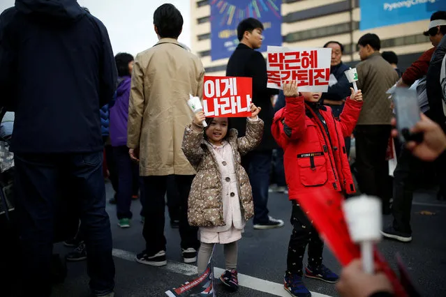 Children hold up signs during a protest calling South Korean President Park Geun-hye to step down in Seoul, South Korea, November 19, 2016. The sign reads “Step down Park Geun-hye immediately”. (Photo by Kim Hong-Ji/Reuters)