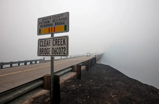 Smoke from the Carr Fire shrouds the Clear Creek Bridge near Igo, California, U.S. July 29, 2018. (Photo by Bob Strong/Reuters)