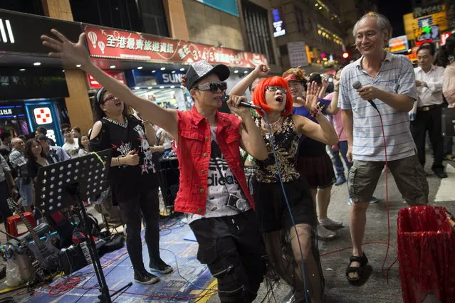 Buskers performing in Sai Yeung Choi Street South in Mongkok district, Hong Kong, China, 28 July 2018. (Photo by Jerome Favre/EPA/EFE)