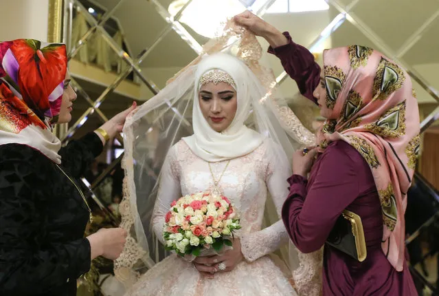 The bride stands in a place where she is to remain during her wedding in Chechen capital Grozny, Russia on November 24, 2016. (Photo by Valery Sharifulin/TASS)