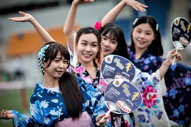 Visitors wearing traditional Japanese clothes pose for a photo during the 47th Bon Odori Festival in Selangor, Malaysia on July 22, 2023. Bon Odori is a Japanese folk dance that is usually accompanied by singing and dancing with the lively rhythm of drums, gongs and flutes. The mid-year festival is held annually as a popular get-together summer event in every district of every city in Japan. (Photo by Syaiful Redzuan/Anadolu Agency via Getty Images)