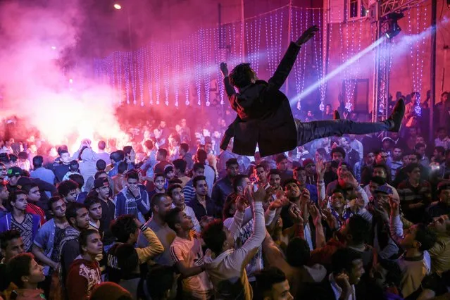 In this Thursday, March 5, 2015 photo, youth dance at a local wedding in Salam City, a suburb on the outskirts of Cairo. Since the 2011 uprising, the music of "Mahraganat," Arabic for "festivals," has emerged from and spread through impoverished communities, where local musicians play, especially during weddings, their auto-tuned beats and songs that tackle social, political and cultural issues. (AP Photo/Mosa'ab Elshamy)