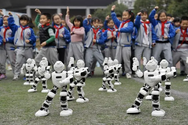 The students are watching the robots doing Tai Chi at the 6th science and technology innovation education festival on 22th November, 2020 in Chengdu, Sichuan, China. (Photo by TPG/Getty Images)