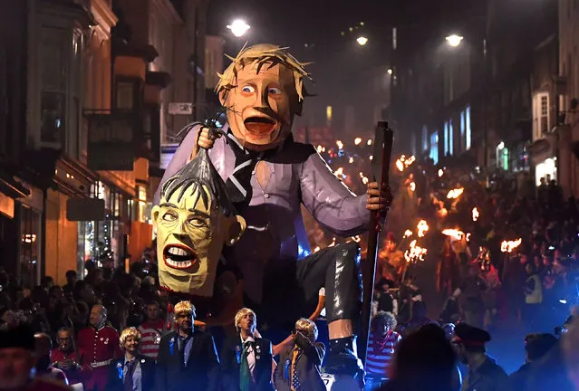 An effigy of British politician Boris Johnson is pulled on a cart as participants parade through the town during the annual Bonfire Night festivities in Lewes, Britain on November 5, 2018. (Photo by Toby Melville/Reuters)