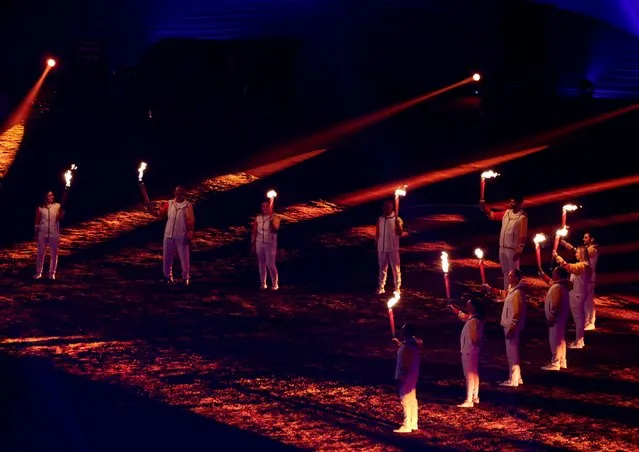 Former Chilean athletes hold torches before the cauldron is lit at the Opening Ceremony of the Pan-Am Games in Santiago, Chile on October 20, 2023. (Photo by Pilar Olivares/Reuters)