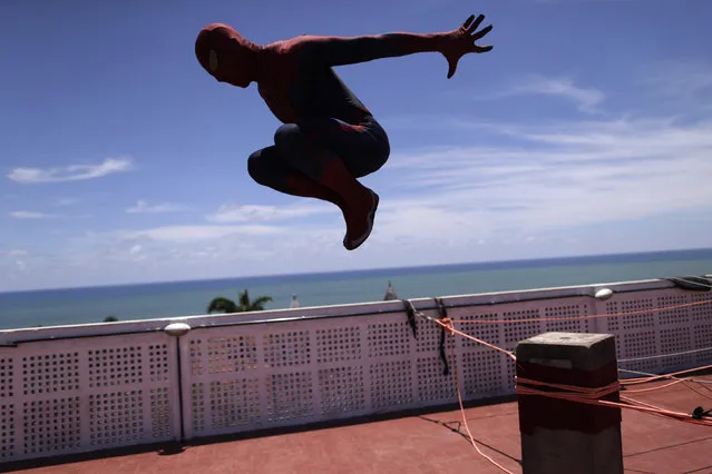 A reveller dressed as Spider-Man takes part in a presentation at the top of a building during an annual block party known as “Enquanto isso na Sala da Justiça” (Meanwhile, in the justice room) one of the many carnival parties taking place in the neighbourhood of Olinda, Brazil February 7, 2016. (Photo by Ueslei Marcelino/Reuters)