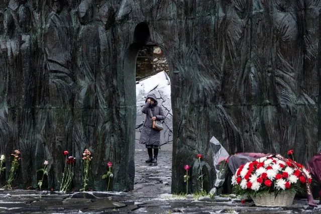 A woman makes the sign of the cross at the Wall of Grief monument on a remembrance day for the victims of political repressions in Moscow, Russia on October 30, 2023. (Photo by Maxim Shemetov/Reuters)