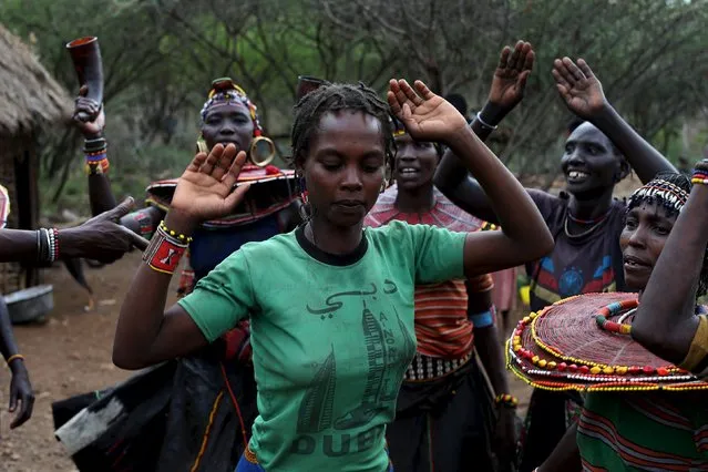 Pokot women dance in celebration the day before an initiation ceremony for young men in Baringo County, Kenya, January 19, 2016. (Photo by Siegfried Modola/Reuters)