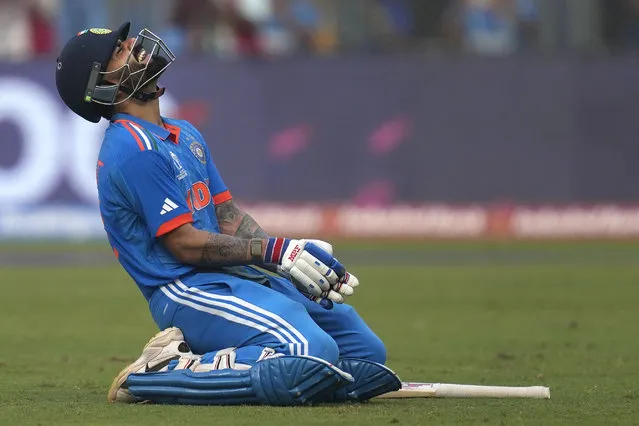 India's Virat Kohli celebrates his century during the ICC Men's Cricket World Cup first semifinal match between India and New Zealand in Mumbai, India, Wednesday, November 15, 2023. (Photo by Rafiq Maqbool/AP Photo)