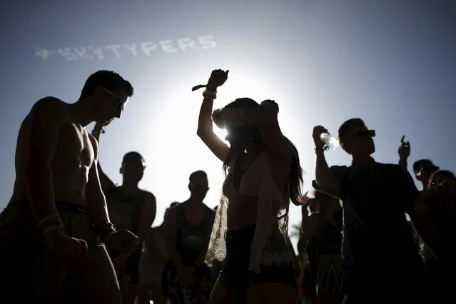 People dance at the Coachella Valley Music and Arts Festival in Indio, California April 11, 2015. (Photo by Lucy Nicholson/Reuters)