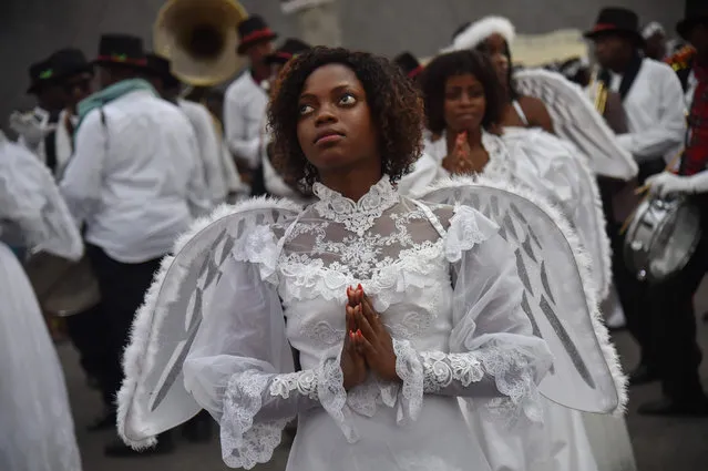 A young Haitian woman dressed in an angel costume participates in a Christmas Parade (Parad Nwel in Haitian creole) on the streets of the commune of Petion Ville, in the Haitian capital Port-au-Prince, on December 23, 2018. (Photo by Héctor Retamal/AFP Photo)