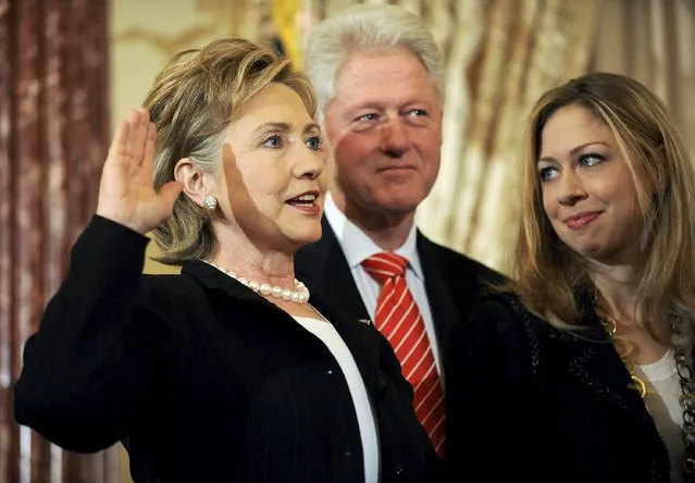 US Secretary of State Hillary Clinton (L) is joined by her husband former U.S. President Bill Clinton and daughter Chelsea Clinton as she is ceremonially sworn in at the State Department in Washington, in this February 2, 2009 file photo. (Photo by Jonathan Ernst/Reuters)