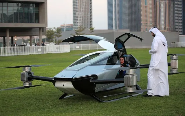 Emiratis inspect the eVTOL flying car X2 during the world-first public flight as part of the Gulf Information Technology Exhibition (GITEX) Global 2022 at the runway of SkyDive Dubai in the Gulf emirate of Dubai, United Arab Emirates, 10 October 2022. In partnership with the Dubai International Chamber, XPENG and EV manufacturer specialised in designing, developing, manufacturing, and marketing intelligent mobility solutions has chosen Dubai to be hosting exclusively the world-first public flight of its pioneering eVTOL flying car X2. (Photo by Ali Haider/EPA/EFE/Rex Features/Shutterstock)