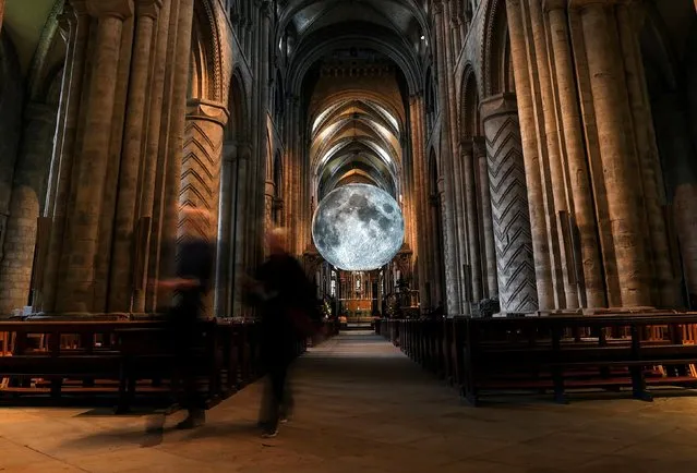 People visit Luke Jerram's “Museum of the Moon” art installation inside Durham Cathedral in Durham, Britain September 13, 2021. (Photo by Lee Smith/Reuters)