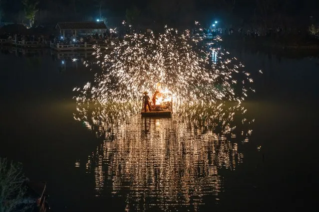 Craftsmen perform molten iron fireworks at a tourist attraction during the three-day New Year's Day holiday on December 30, 2023 in Feidong County, Hefei City, Anhui Province of China. (Photo by Ruan Xuefeng/VCG via Getty Images)