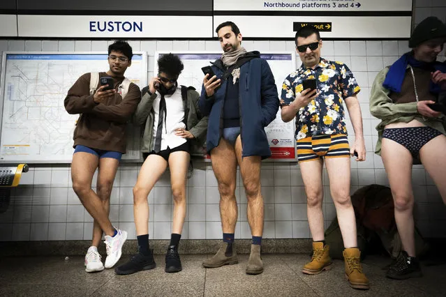 People at Euston Station take part in the annual No Trousers Tube Ride, London, Sunday, January 7, 2024. (Photo by James Manning/PA Wire via AP Photo)