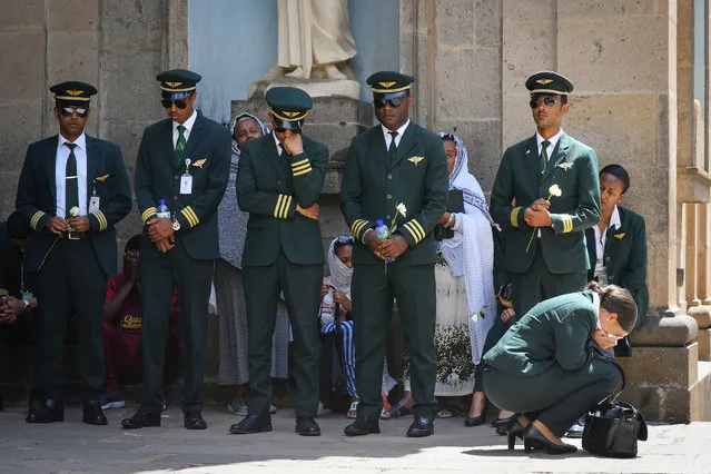 Pilots and crew members of the Ethiopian Airlines react as they attend a burial service for the victims of the Ethiopian Airlines plane crash at the Holy Trinity Cathedral in Addis Ababa, Ethiopia, 17 March 2019. Ethiopian Airlines flight ET 302 carrying 149 passengers and 8 crew was en route to Nairobi, Kenya, when it crashed on 10 March 2019 by yet undetermined reason. All passengers and crew aboard died in the crash. The Boeing 737 Max 8 aircraft has come under scrutiny after similar deadly crashes in Ethiopia and Indonesia within a few months. Several countries have banned the plane type from their airspace and many airlines have grounded their 737 Max 8 planes for safety concerns after the Ethiopian Airlines plane crashed minutes after take-off. (Photo by EPA/EFE/Stringer)