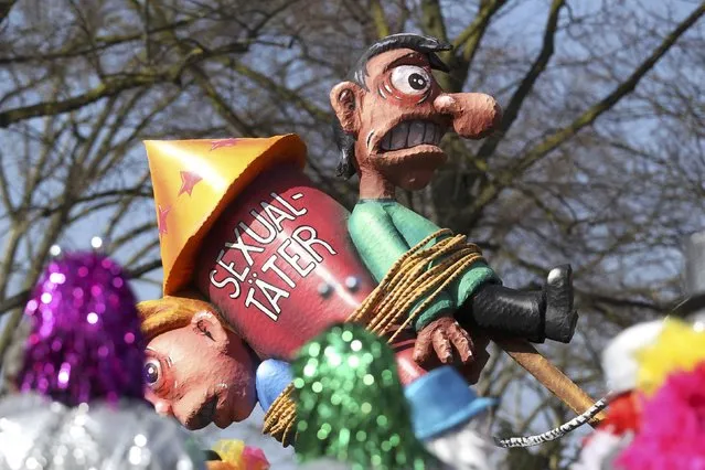 A carnival float with papier-mache caricatures featuring a rocket with two “sexual offenders” chained to it alluding to the sexual assaults in New Year's Eve, is displayed at a postponed “Rosenmontag” (Rose Monday) parade, at one location in Duesseldorf, Germany, March 13, 2016, after the original parade in February was cancelled due to severe weather. (Photo by Ina Fassbender/Reuters)