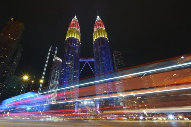 Petronas Twin towers decorated with colour lights during the 64th National Day celebrations to commemorate independence of Malaysia from British colonial rule, in Kuala Lumpur, Malaysia, Tuesday, August 31, 2021. (Photo by Vincent Thian/AP Photo)