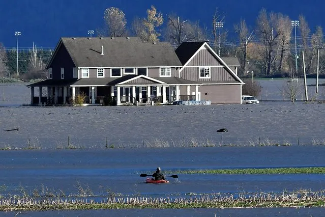 A paddler kayaks on a flooded stretch of farmland after rainstorms lashed the western Canadian province of British Columbia, triggering landslides and floods and shutting highways, in Abbotsford, British Columbia, Canada November 16, 2021. (Photo by Jennifer Gauthier/Reuters)