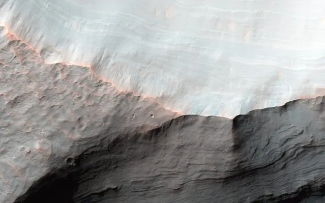 A handout picture made available by the NASA on 24 March 2016 of alluvial fans in Saheki Crater on Mars, captured on 23 January 2016. Alluvial fans are gently-sloping wedges of sediments deposited by flowing water. This observation, captured on 23 January 2016 by the High Resolution Imaging Science Experiment (HiRISE) camera on NASA's Mars Reconnaissance Orbiter, covers two impact craters that expose the stratigraphy of the fans. (Photo by EPA/NASA/JPL-Caltech/University of Arizona)