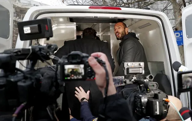 Former professional kickboxer and social media influencer Andrew Tate (R) shouts to members of the media, while being taken into the police van by Romanian police officers, after being questioned at the Directorate for Investigating Organized Crime and Terrorism (DIICOT) in Bucharest, Romania, 26 January 2023. On 29 December 2022, Andrew Tate and his brother Tristan were arrested as a result of the DIICOT inquiry under the charges of human trafficking and intention to form an organized crime group. Romanian police stated that the two brothers and their associates coerced victims for creating a paid p*rnography service for social media platforms. (Photo by Robert Ghement/EPA/EFE)