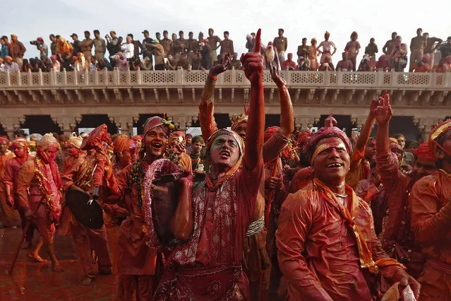 People dance as others spray coloured water on them during the “Lathmar Holi” at village Nandgaon, in the northern Indian state of Uttar Pradesh, March 10, 2014. (Photo by Adnan Abidi/Reuters)