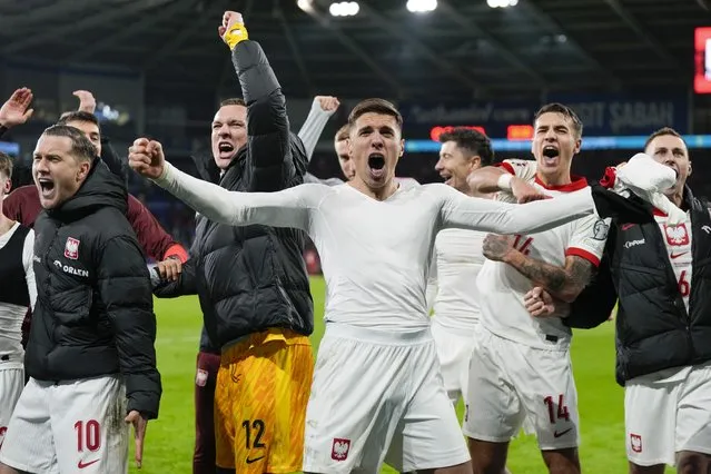 Poland players celebrate after defeating Wales in a penalty shoot out during their Euro 2024 soccer play-off match at Cardiff City Stadium, Wales, Tuesday, March 26, 2024. (Photo by Alastair Grant/AP Photo)