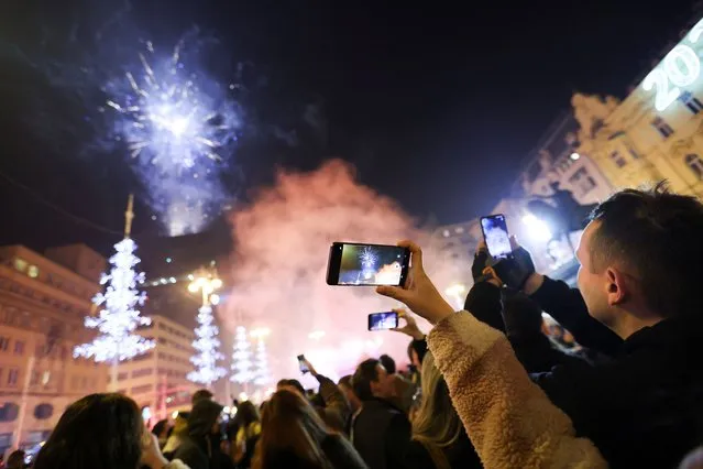 People celebrate New Year's Eve at Zagreb's main square, amid the coronavirus disease (COVID-19) pandemic, Croatia, January 1, 2022. (Photo by Antonio Bronic/Reuters)
