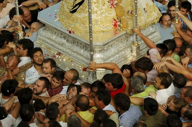 The Virgin of El Rocio is carried by pilgrims during a procession around the shrine of El Rocio in Almonte, southern Spain, May 25, 2015. Every spring hundreds of thousands of devotees converge at a shrine to pay homage to the Virgin del Rocio during an annual pilgrimage which combines religious fervour and festive colour. (Photo by Marcelo del Pozo/Reuters)