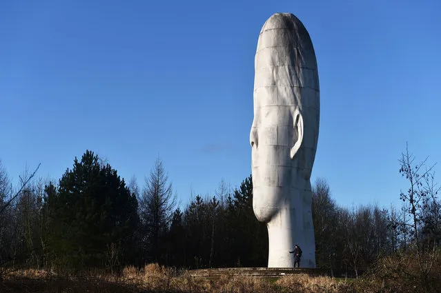 People visit The Dream Sculpture which has recently featured in Netflix’s thriller Stay Close on January 05, 2022 in St Helens, England. The 20 metre high sculpture of a young girl's face in a dream-like state, by French artist Jaume Plensa, was chosen in 2009 by a group of ex-miners who worked in the former colliery where it stands in Sutton Manor, St Helens. (Photo by Nathan Stirk/Getty Images)