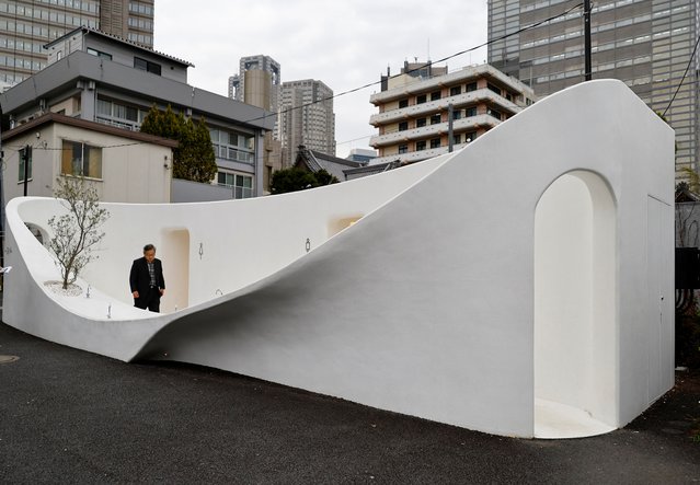 A participant looks around a public toilet which was redesigned as part of a project to transform public toilets into restrooms that can be used comfortably by everyone, during a Tokyo Toilet Shuttle Tour, at Shibuya ward, in Tokyo, Japan on April 4, 2024. (Photo by Kim Kyung-Hoon/Reuters)