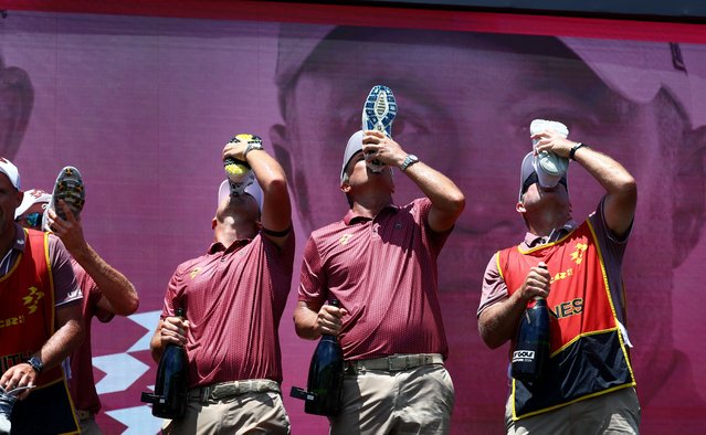 Cameron Smith, Marc Leishman, Lucas Herbert and Matt Jones of Ripper GC drink champagne out of their shoes alongside their caddies as they celebrate winning the team title at the LIV Golf tournament in Singapore on May 5, 2024. (Photo by Edgar Su/Reuters)