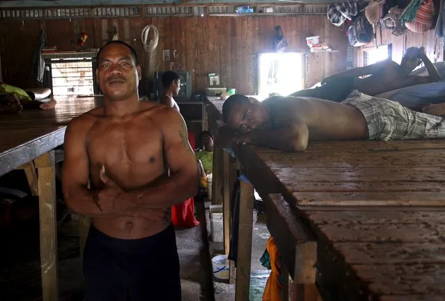 Prisoner Katokiau Maruai (L), stands next to inmates inside the sleeping dormitory of a prison located on Kiritimati Island, part of the Pacific Island nation of Kiribati, April 5, 2016. (Photo by Lincoln Feast/Reuters)