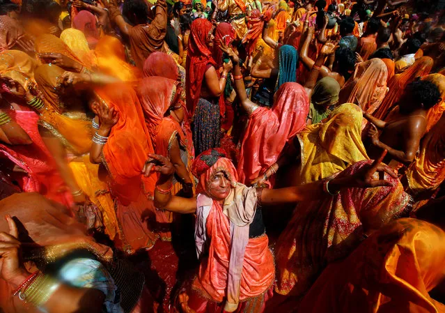 A woman dances during “Huranga”, a game played between men and women a day after Holi, at Dauji temple near Mathura, March 14, 2017. (Photo by Adnan Abidi/Reuters)