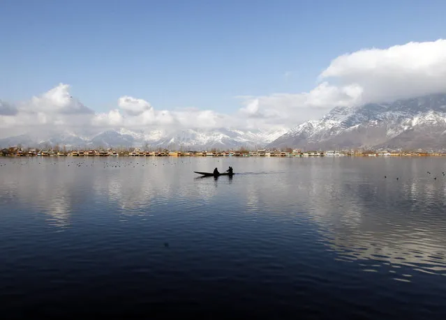 A man rows a small boat on the waters of Dal Lake on a sunny day in Srinagar February 4, 2015. (Photo by Danish Ismail/Reuters)