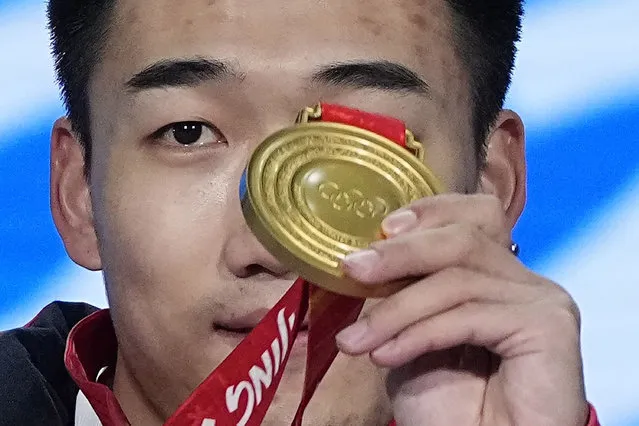 Gao Tingyu of China holds up his gold medal during the medal ceremony for the men's 500-meter speedskating at the 2022 Winter Olympics, Saturday, February 12, 2022, in Beijing. (Photo by Jae C. Hong/AP Photo)