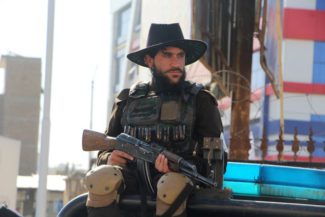 A Taliban security personnel stands guard as people prepare for Eid Al Adha prayers at a mosque in Kandahar, Afghanistan, 17 June 2024. Eid al-Adha is the holiest of the two Muslim holidays celebrated each year. It marks the yearly Muslim pilgrimage (Hajj) to visit Mecca, the most sacred place in Islam. Muslims slaughter a sacrificial animal and split the meat into three parts: one for the family, one for friends and relatives, and one for the poor and needy. (Photo by Qudratullah Razwan/EPA/EFE)