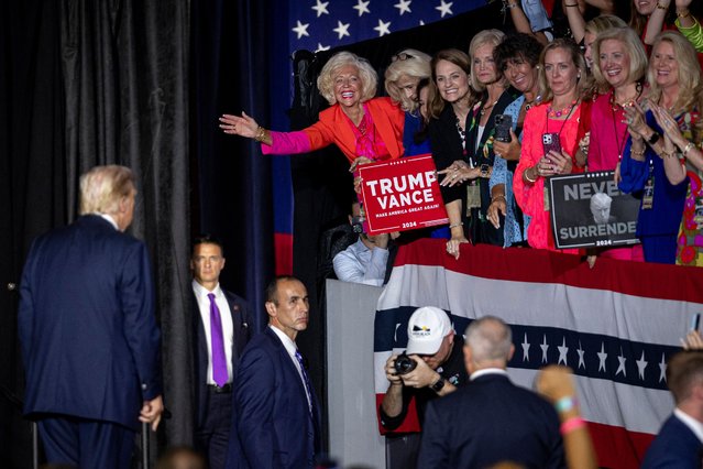 Supporters react as former US President and 2024 Republican presidential candidate Donald Trump takes in the crowd after speaking during a campaign rally at the Bojangles Coliseum in Charlotte, North Carolina, on July 24, 2024. (Photo by Logan Cyrus/AFP Photo)