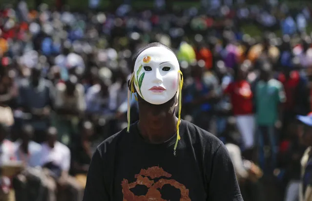 A supporter of the opposition Coalition for Reforms and Democracy (CORD), led by former Prime Minister Raila Odinga, wears a mask and looks on during a rally held in Nairobi, Kenya, 01 June 2016. Kenyan opposition staged a rally on Madaraka Day, the national holiday to commemorate the day that Kenya attained internal self-rule from Britain in 1963, to protest against the country's electoral body Independent Electoral and Boundaries Commission (IEBC) and push for reforms ahead of the next year's general elections. (Photo by Dai Kurokawa/EPA)