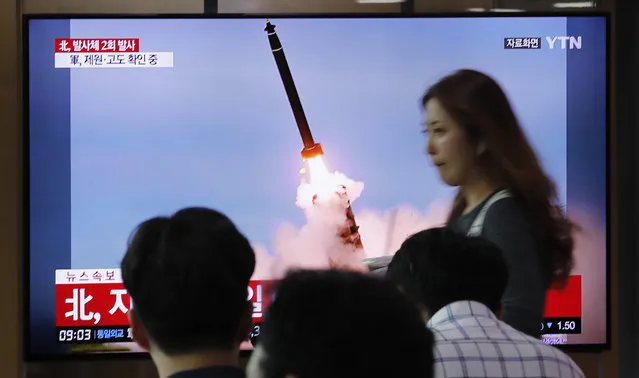 People watch a TV showing a file image of an unspecified North Korea's missile launch during a news program at the Seoul Railway Station in Seoul, South Korea, Tuesday, September 10, 2019. North Korea launched at least two unidentified projectiles toward the sea on Tuesday, South Korea's military said, hours after the North offered to resume nuclear diplomacy with the United States but warned its dealings with Washington may end without new U.S. proposals. The sign reads “North Korea launched at least two unidentified projectiles”. (Photo by Ahn Young-joon/AP Photo)